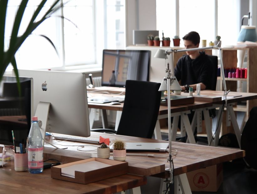 Clean modern office space with desks and chairs