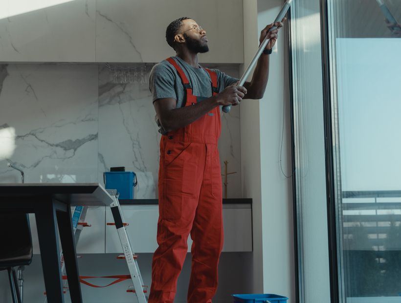 Worker cleaning a newly renovated interior